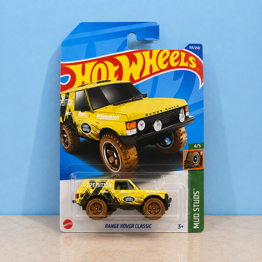 A Hot Wheels die-cast toy car of the Yellow Range Rover Classic &